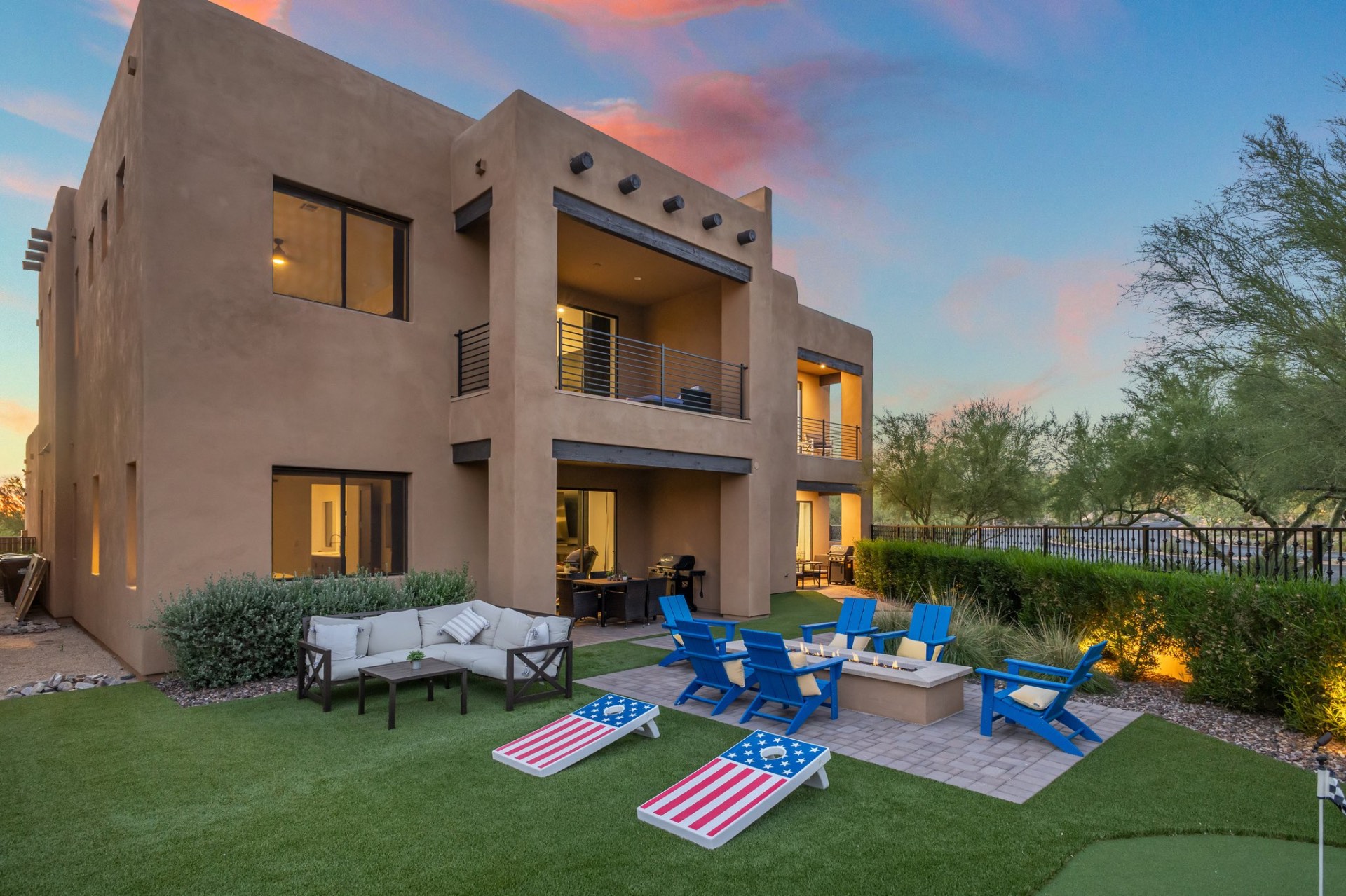 Exterior lawn and fire pit at The Villas Scottsdale at sunset