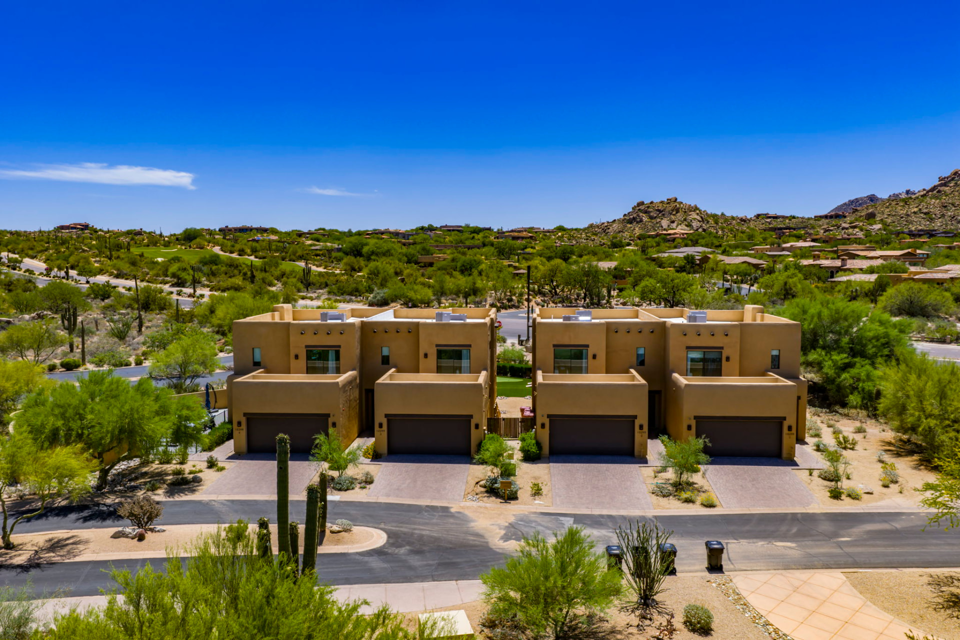 Aerial view of all four The Villas Scottsdale with the North Scottsdale desert and mountains behind