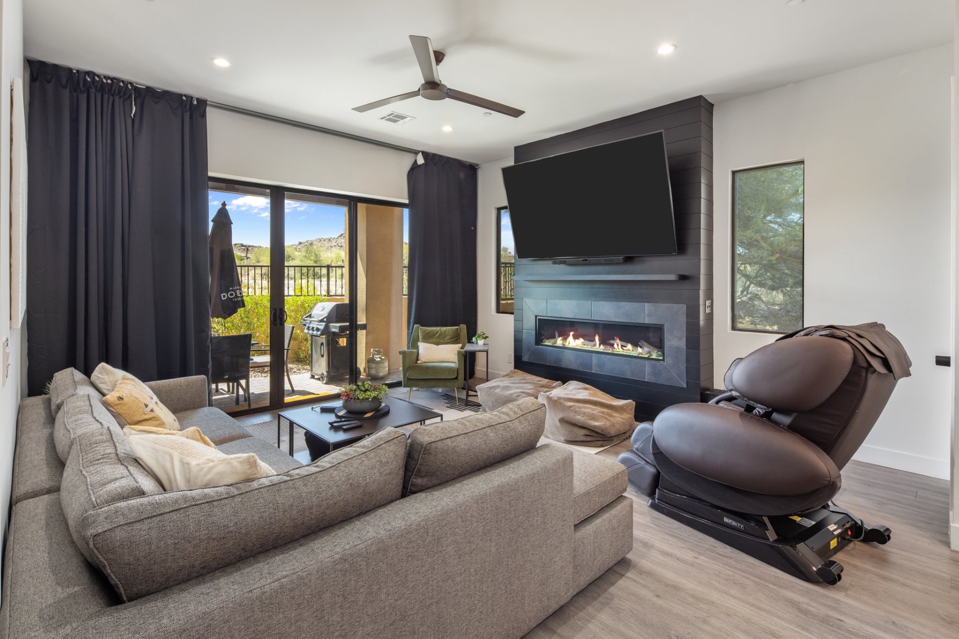 Living room with fireplace and mountain views at The Villas Scottsdale